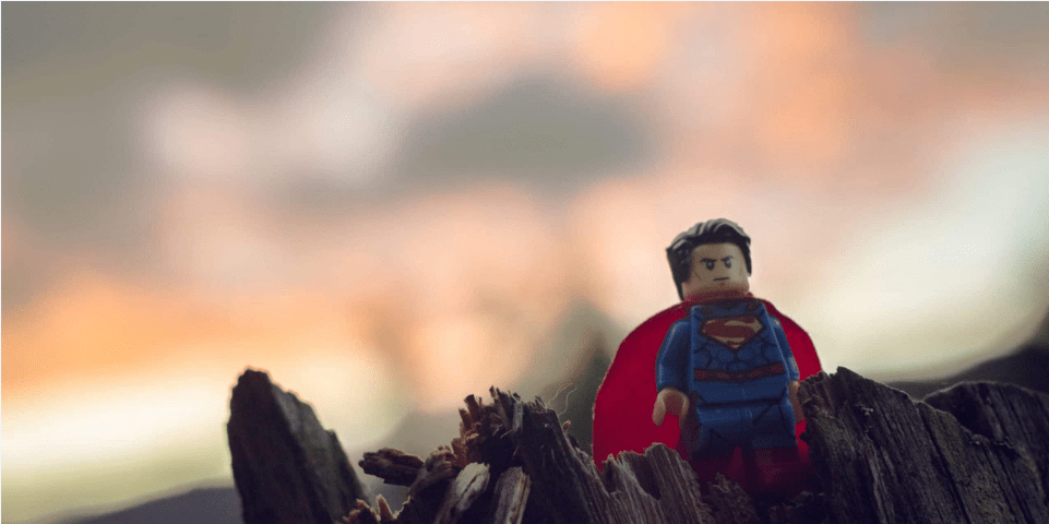 Lego superman figure on bark