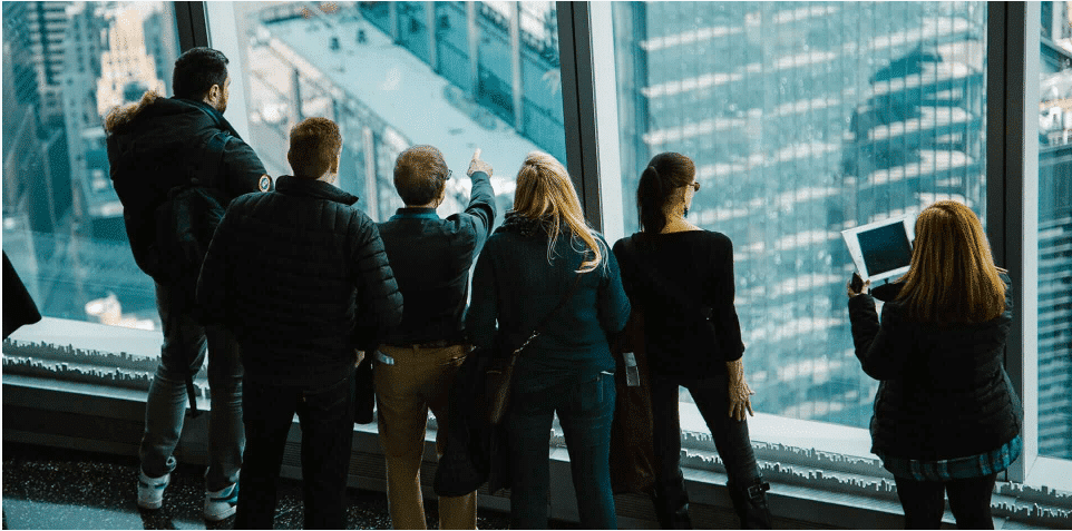 People standing in front of a window looking out