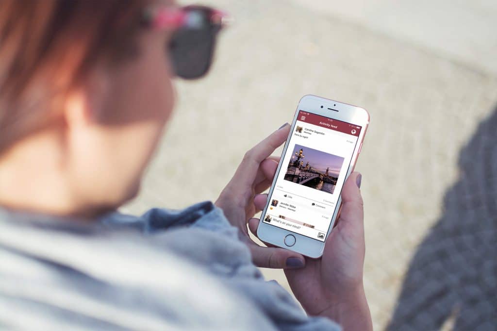 Man using checking activity feed on his smartphone